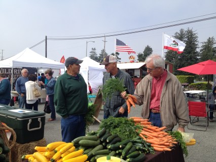 That's Robert Presler in the middle talking with a friend while Paul checks out the organic carrots. Where ever Robert goes, he finds friends to talk with.